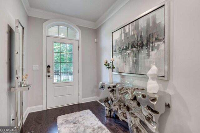 foyer featuring ornamental molding and dark wood-type flooring