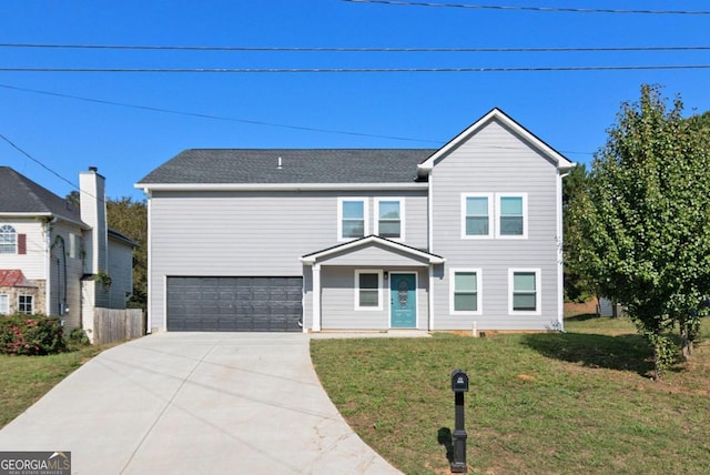 view of front of house featuring a front yard and a garage