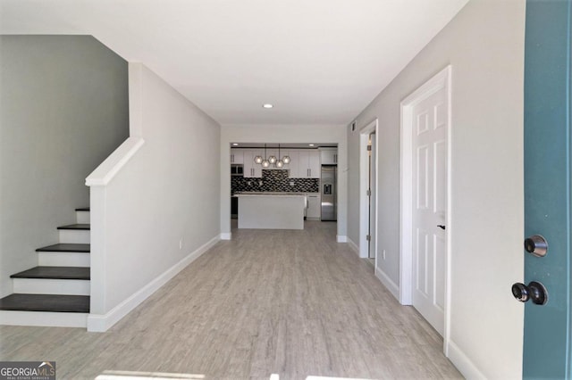 hallway with light hardwood / wood-style flooring