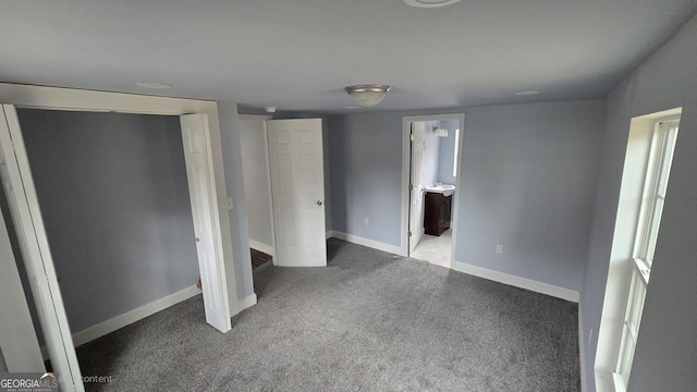 unfurnished bedroom with carpet flooring and ensuite bathroom