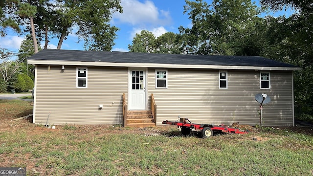 back of house with a lawn