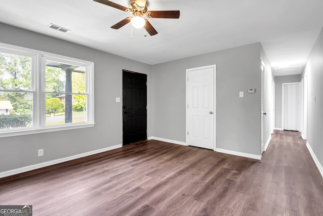 spare room with ceiling fan and dark hardwood / wood-style flooring