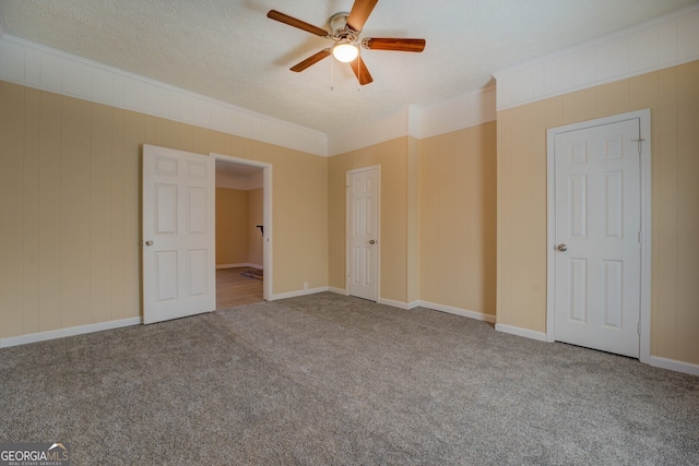 unfurnished bedroom with ceiling fan, carpet flooring, and a textured ceiling