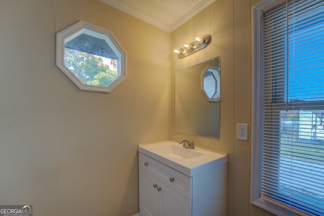 bathroom featuring a wealth of natural light, vanity, and ornamental molding