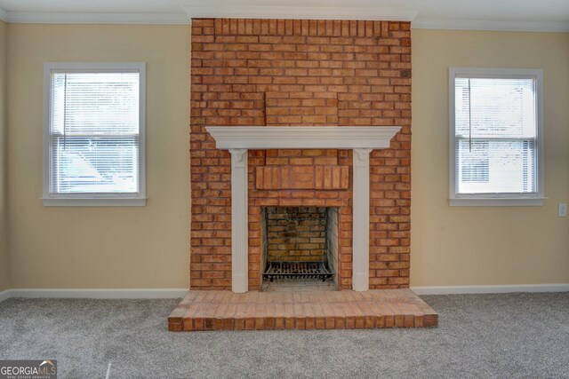 unfurnished living room featuring ornamental molding, a fireplace, and carpet floors