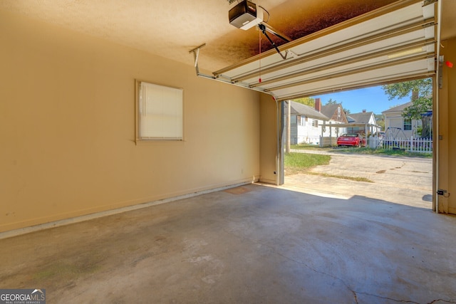 garage with a garage door opener and a carport