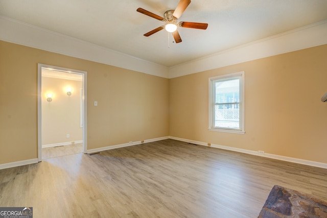 unfurnished room featuring ceiling fan, crown molding, and light hardwood / wood-style flooring