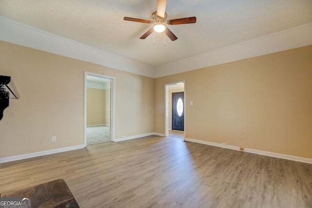 interior space featuring light hardwood / wood-style floors, ornamental molding, and ceiling fan