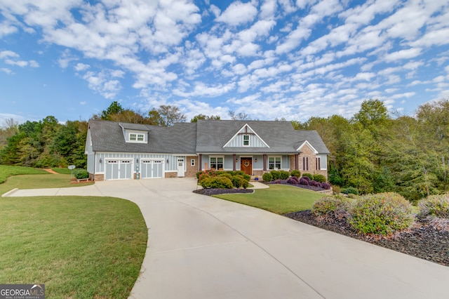 view of front of home with a front yard and a garage