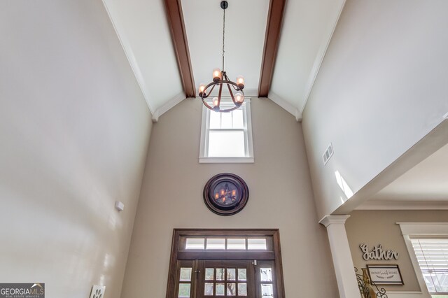 dining area featuring crown molding, a notable chandelier, vaulted ceiling, and dark hardwood / wood-style flooring