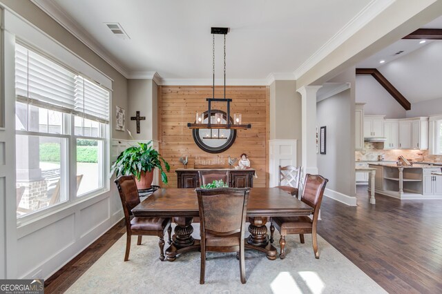 dining area featuring ornamental molding, ornate columns, and dark hardwood / wood-style flooring