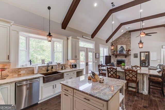 kitchen featuring a kitchen island, backsplash, dishwasher, dark wood-type flooring, and sink