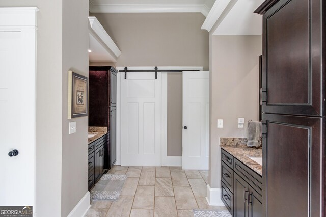 bathroom with vanity, ornamental molding, and tile patterned floors