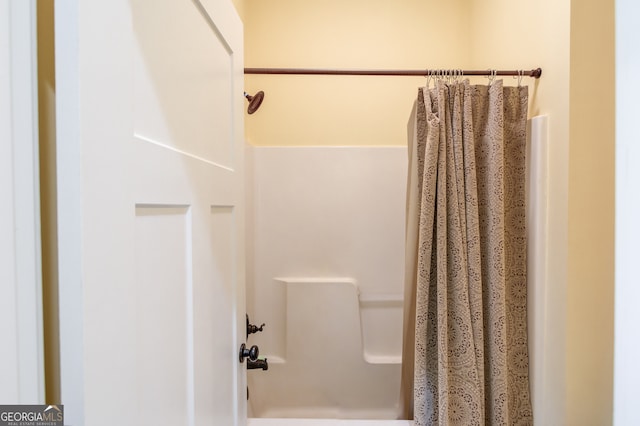 bathroom with a shower with shower curtain