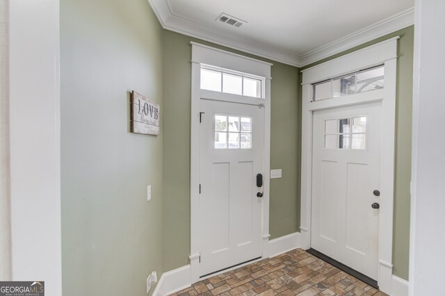 foyer entrance featuring crown molding