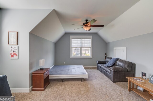 bedroom with ceiling fan, light carpet, and vaulted ceiling