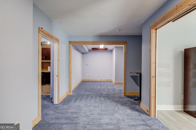 hall featuring carpet flooring