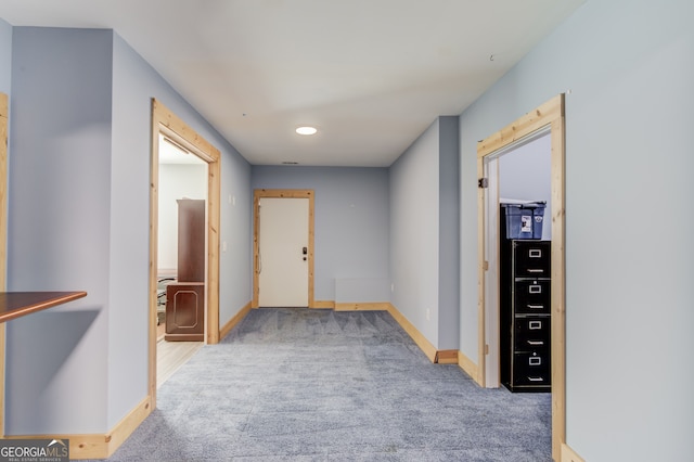 hallway with light colored carpet