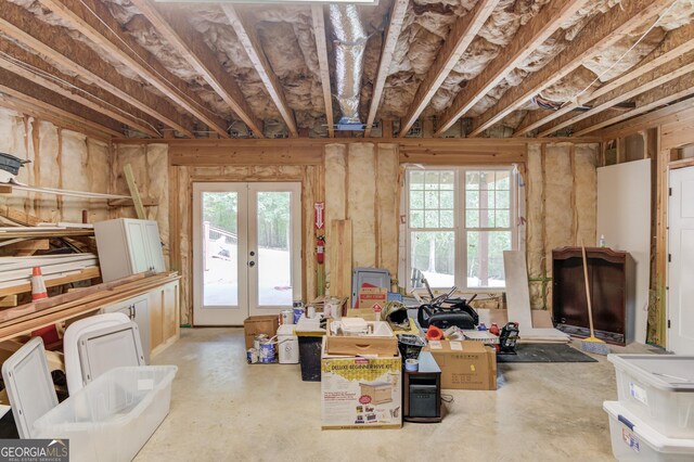 miscellaneous room with french doors and concrete flooring