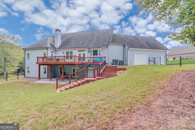 back of property featuring a garage, a yard, a deck, and a patio area