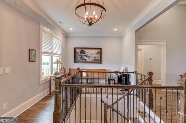 hall featuring ornamental molding, an inviting chandelier, and dark hardwood / wood-style floors