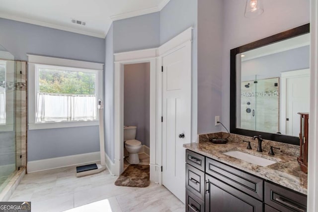 bathroom featuring a shower with door, vanity, ornamental molding, and toilet