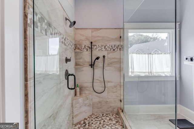 bathroom featuring a shower with door and tile patterned flooring