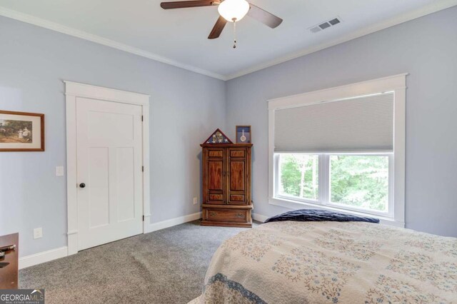 carpeted bedroom featuring ornamental molding and ceiling fan