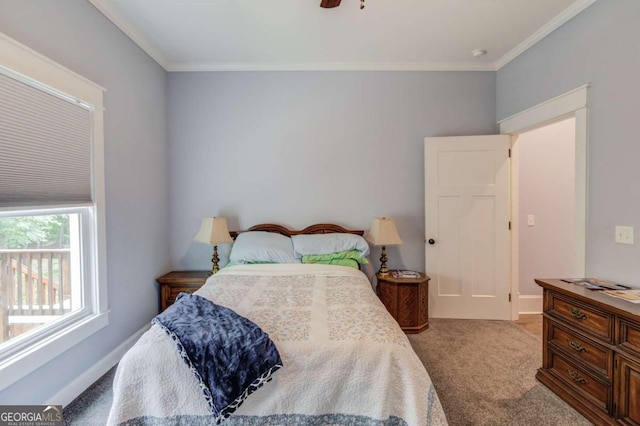 carpeted bedroom with crown molding and ceiling fan