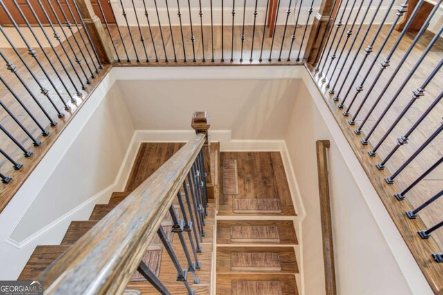 stairs featuring hardwood / wood-style flooring