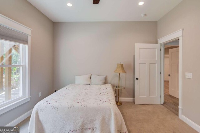 bedroom with ceiling fan and light colored carpet