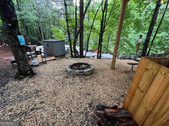 view of yard featuring a patio and an outdoor fire pit