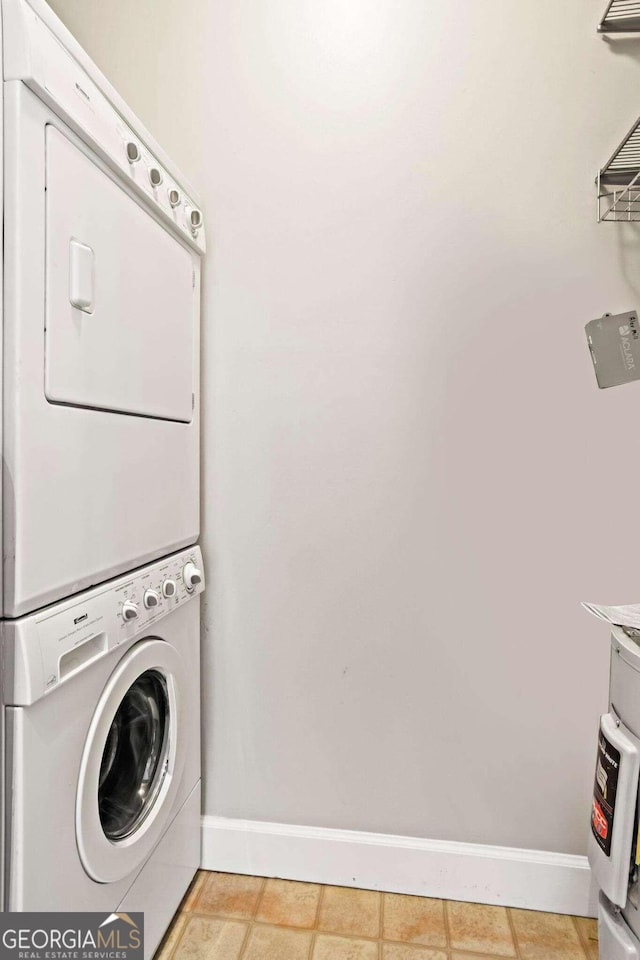 washroom featuring stacked washing maching and dryer