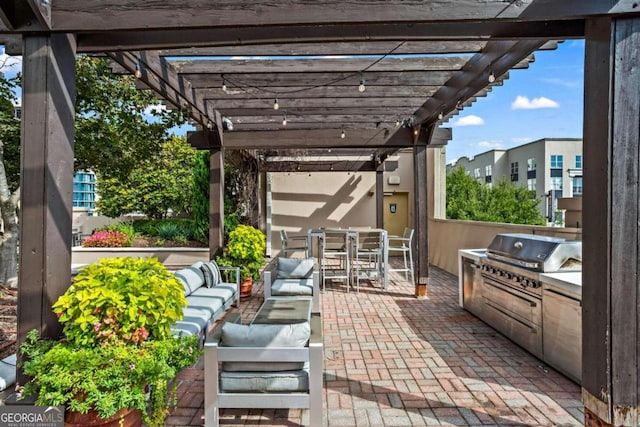 view of patio with an outdoor kitchen, outdoor lounge area, area for grilling, and a pergola