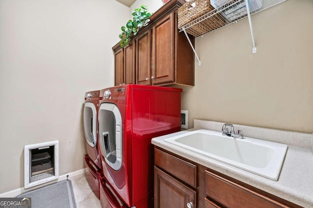 washroom with cabinets, sink, and washing machine and clothes dryer