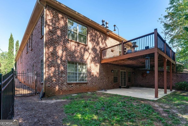 rear view of property with a patio and a wooden deck