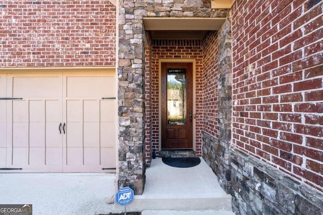 view of exterior entry featuring a garage