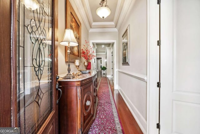 interior space featuring crown molding and dark wood-type flooring