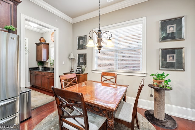 dining space with ornamental molding, dark wood-type flooring, and an inviting chandelier