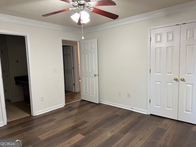 516 Jaclyn Cir, Mcdonough, GA 30253 - unfurnished bedroom with ornamental molding, dark wood-style flooring, a closet, a ceiling fan, and ensuite bathroom