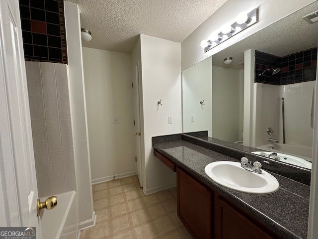 bathroom featuring visible vents, vanity, a textured ceiling, shower / tub combination, and tile patterned floors