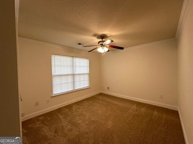 unfurnished room with a textured ceiling, a ceiling fan, baseboards, ornamental molding, and dark colored carpet