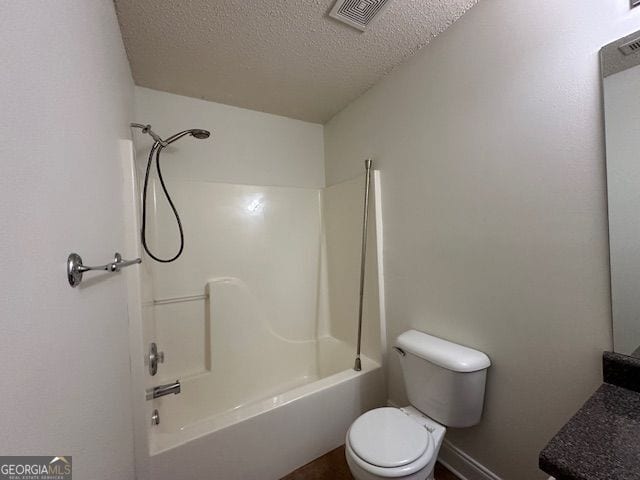 full bath featuring toilet, bathtub / shower combination, visible vents, and a textured ceiling