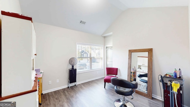 living area featuring vaulted ceiling and dark hardwood / wood-style floors