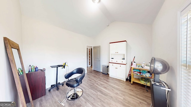 miscellaneous room with lofted ceiling and light hardwood / wood-style flooring