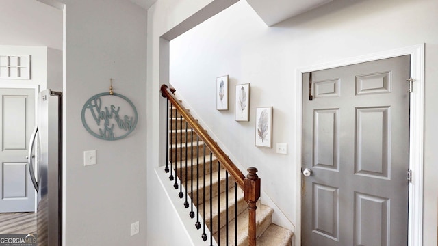 staircase featuring hardwood / wood-style flooring