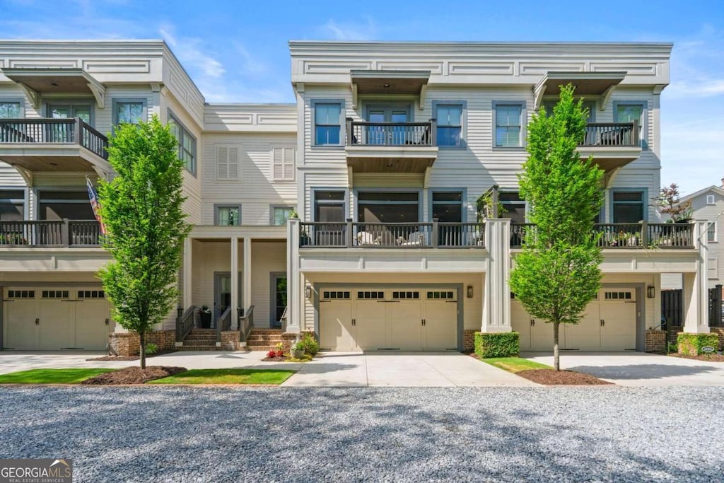 multi unit property with a balcony and a garage