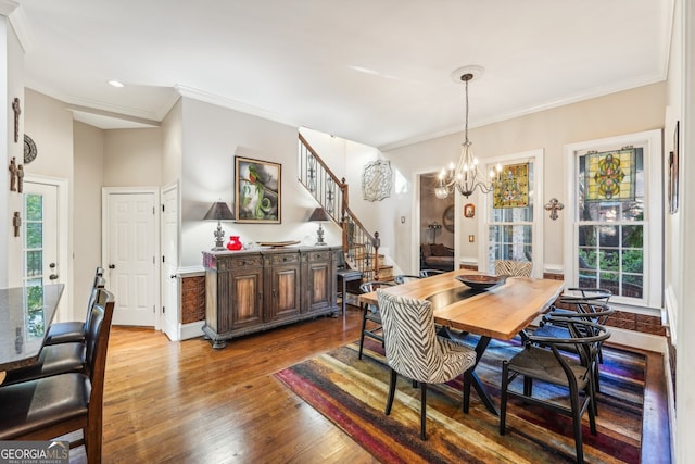 dining room featuring crown molding, hardwood / wood-style flooring, and plenty of natural light