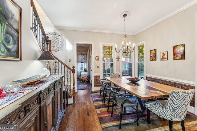 dining room featuring crown molding, an inviting chandelier, and dark hardwood / wood-style flooring