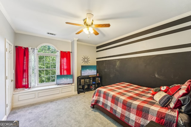 carpeted bedroom featuring ornamental molding and ceiling fan